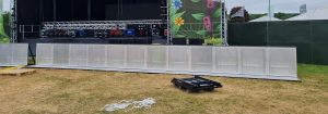 A sturdy front of stage barrier designed to manage audience flow and enhance safety at live events. Constructed from durable materials, it provides a clear demarcation between the audience and the performance area