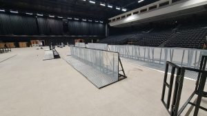 A combi aluminum front-of-house barrier, featuring a lightweight yet robust construction. The barrier includes an adjustable height mechanism, allowing for flexible setup configurations. Ideal for controlling access to performance areas while maintaining an unobstructed view for the audience